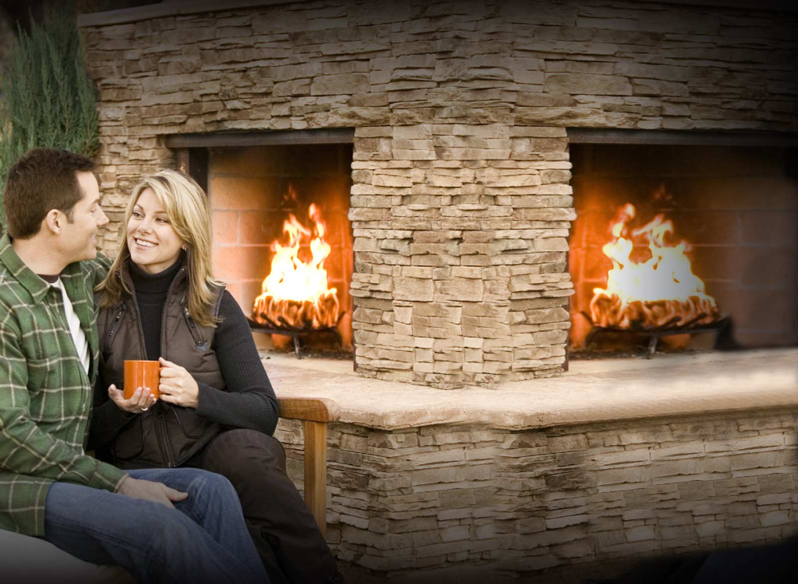 picture of man and woman sitting by fireplace